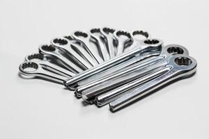 A row of tools are shown, including a pair of pliers and a wrench photo