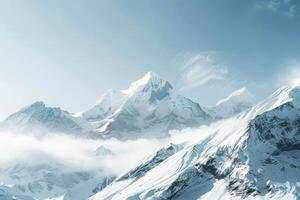 A mountain range with snow and clouds photo
