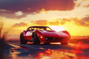 A red sports car driving down a road at sunset photo