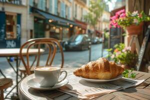 A croissant and coffee on a table in paris photo