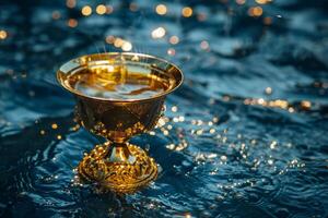 Golden goblet on water with sparkles photo