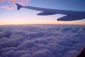 An airplane wing is seen flying over clouds photo