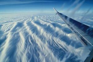A view of the wing of an airplane flying through the clouds photo