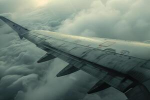 A view of the wing of an airplane flying through the clouds photo