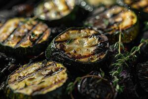 Slices of zucchini and lemon are beautifully grilled, displaying charred patterns, while fresh thyme adds a touch of green, capturing the essence of summer cooking photo