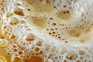 A rich layer of frothy bubbles rests on top of golden beer in a pint glass, showcasing its refreshing qualities and inviting aroma perfect for a warm afternoon photo