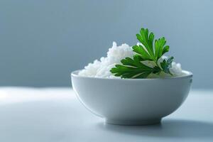 A bowl filled with fluffy white rice is beautifully garnished with a sprig of fresh parsley, creating an appealing culinary presentation photo