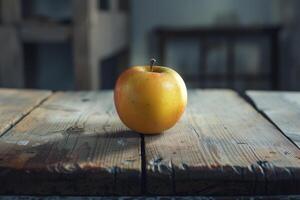 A single golden apple is positioned on a weathered wooden table, catching soft light that enhances its vibrant color in a warm, inviting atmosphere photo