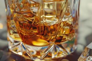 A crystal glass holds rich amber whiskey with ice cubes, beautifully reflecting light on a stylish tabletop, creating a warm and inviting atmosphere photo
