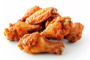 A tempting arrangement of golden-brown fried chicken wings is displayed prominently against a clean white backdrop, perfect for showcasing delicious dishes photo