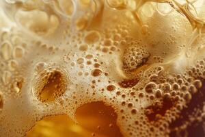 A close-up view reveals golden beer foam with bubbles rising in a glass, highlighting its refreshing texture and thirst-quenching characteristics during a sunny day photo
