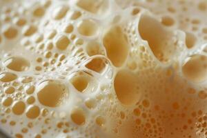 A close-up view captures the frothy surface of freshly brewed coffee, emphasizing the rich texture and inviting aroma. The warm tones create a comfortable atmosphere photo