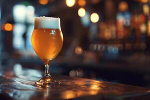 A tall glass filled with golden craft beer sits on a rustic wooden table, surrounded by a softly lit bar ambiance, perfect for a relaxed evening socializing photo