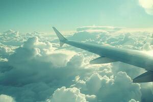 A passenger looks out at a stunning cloudscape from the window seat, enjoying the calm atmosphere of a flight in the afternoon sun photo