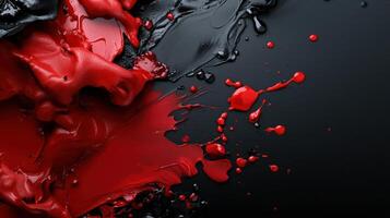 A red and black paint splatter on a black background photo