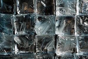 The arrangement features numerous clear ice cubes illuminated softly, highlighting their glossy surfaces and intricate textures, set against a dark background photo