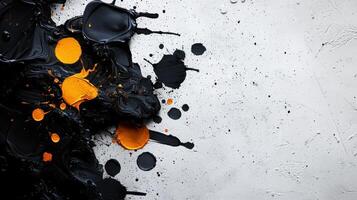 Black and orange paint splashes on a white wall photo