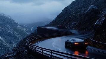 A car driving down a mountain road at night photo