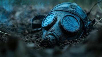 A gas mask laying in the dirt photo