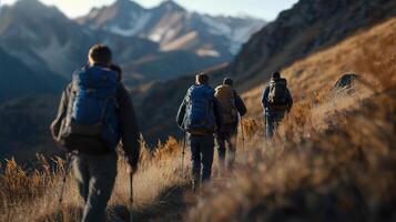 Four people are hiking up a mountain with backpacks photo