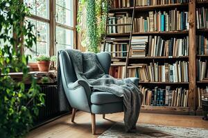 A chair in front of a bookshelf with a blanket photo