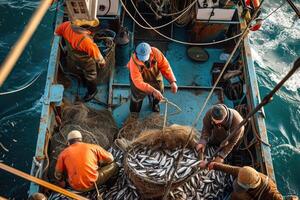 Fishing boat with men loading fish into net photo