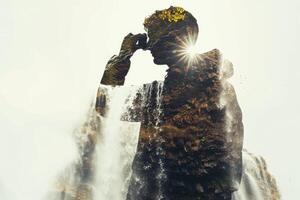 Double exposure of a man standing in front of a waterfall photo