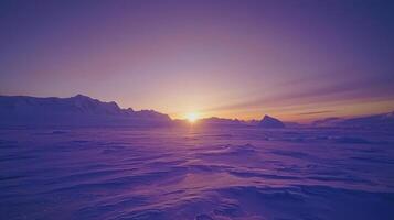 The sun is setting over a snowy landscape photo