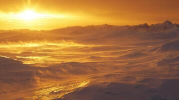 A snowy mountain range with the sun setting behind it photo