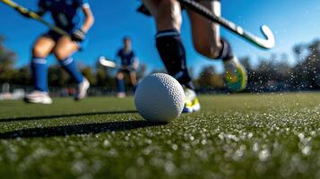 A field hockey ball is being kicked by a player photo