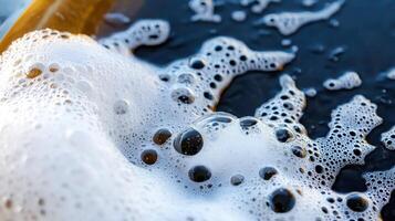 A large amount of foam and bubbles in a tub of water photo
