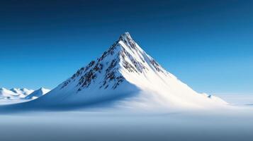 A mountain is covered in snow and is the tallest mountain in the area photo