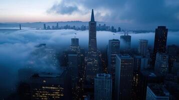 A city skyline is shown in the fog with the sun setting in the background photo