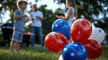 A family of four is enjoying a day at the park, with a bunch of red, white photo