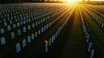 A large cemetery with rows of white headstones photo