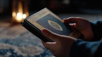 A person is holding a Quran in their hand photo