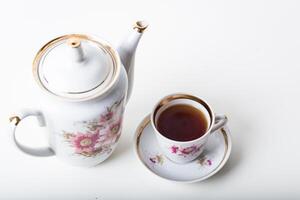 Cup of tea with teapot in vintage style photo