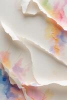 Watercolor paper in pastel colors with torn edges on a white background photo