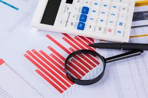 Calculator and magnifying glass on the table photo