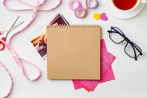 Crafting session with colorful materials and tools on a white table photo