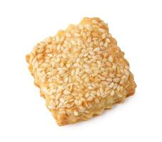 Baked sesame snack with crunchy texture and golden color on a white background photo