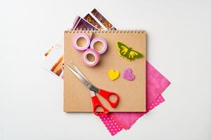 Crafting materials arranged for a colorful creative project on a white background photo