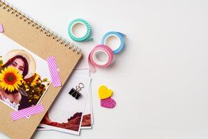 Creative workspace featuring photographs and decorative tape with a sunflower theme in a cozy setting photo