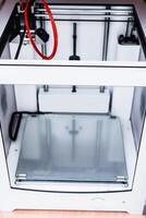 3d printer with bright red filament. photo