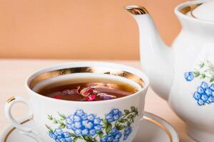 Cup of tea with teapot in vintage style photo