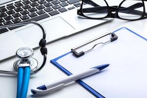 Medical stethoscope on computer keyboard photo