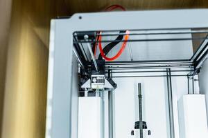 3d printer with bright red filament. photo