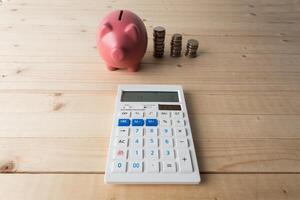 piggy bank with coins and calculator photo