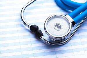 Empty prescription lying on table with stethoscope photo