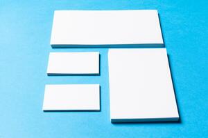 blank office objects organized for company presentation on blue paper background photo